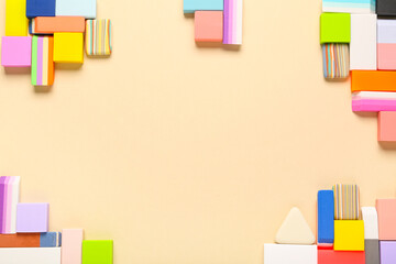 Frame made of different rubber erasers on beige background