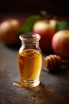 Wellness elixir shot with apple cider vinegar and honey, small glass bottle