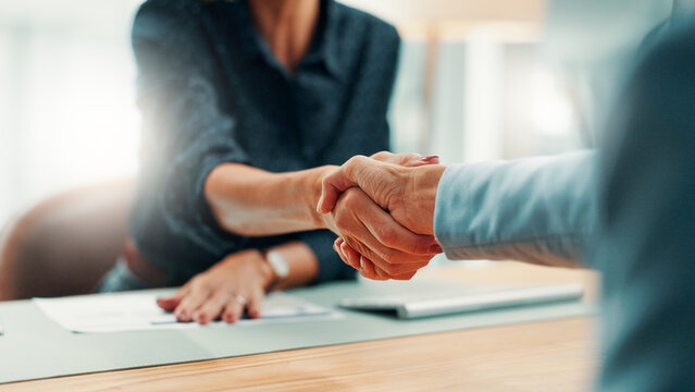 Handshake, deal and business people in office with agreement, contract or finance partnership. Meeting, welcome and financial advisor shaking hands with investor for investment negotiation at agency.