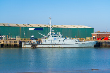 Medium sized cutter, a military style ship moored in a port © Richard O'Donoghue
