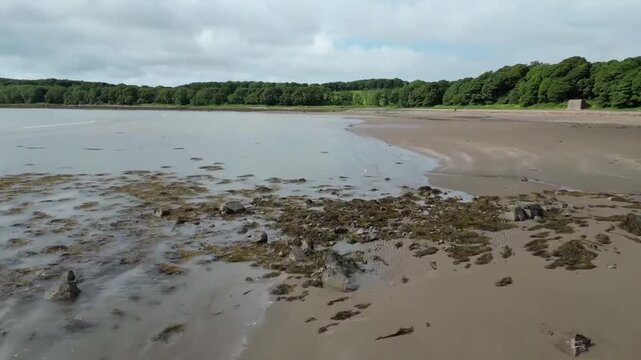 Low Aerial Flight Over Garlieston Bay Tidal Flats and Sandy Shore at Low Tide Scotland UK