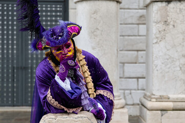 Venice, Italy - February 13, 2026 - People dressed in masks for the Venice Carnival have their photos taken by tourists