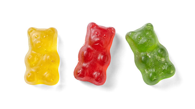 Three colorful gummy bears in yellow, red, and green, neatly arranged on a transparent background.