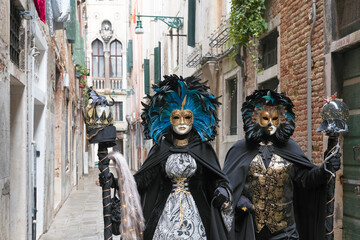 Venice, Italy - February 13, 2026 - People dressed in masks for the Venice Carnival have their...