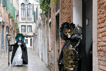 Venice, Italy - February 13, 2026 - People dressed in masks for the Venice Carnival have their...