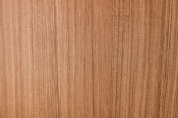 Naklejka premium A light oak or teak wood surface, highlighting a strong vertical grain pattern.