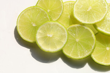 Fresh green lime slices on whiate background.