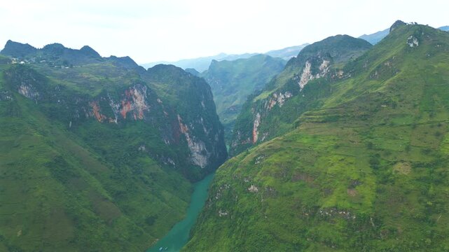 Aerial view of the stunning Tu San Canyon, the deepest canyon in Southeast Asia. Majestic mountains and the turquoise Nho Que River in Ha Giang