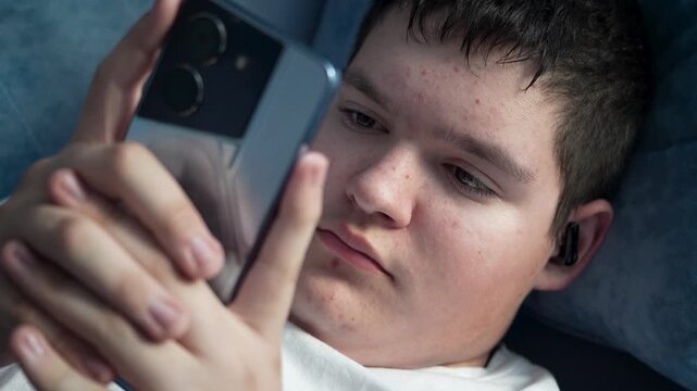 portrait of teenage boy with mobile phone