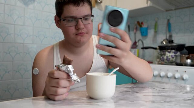 A teenager with diabetes eats candy to control low blood sugar, illustrating sugar harm and diabetes risk. A diabetic raises low blood sugar levels.