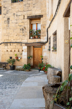 Quiet courtyard square with stone buildings and pots architecture in Valderrobres Aragon Spain captured in daylight for traditional town mood