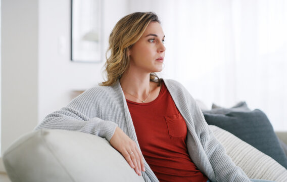 Sad, thinking and woman relax on sofa with unhappy memory, regret mistake and contemplating. Space, thoughtful and person with depression in home for trauma reflection, mental health and overthinking