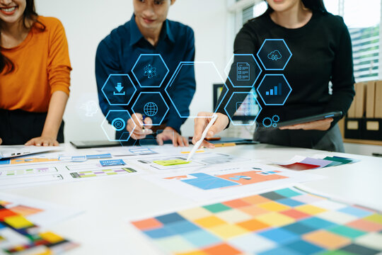Innovative team planning UI UX mobile app interface with digital technology overlay, collaborating on data analytics, product design