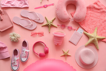 Summer composition with travel pillow, inflatable ring, headphones, starfishes, passport and beach...