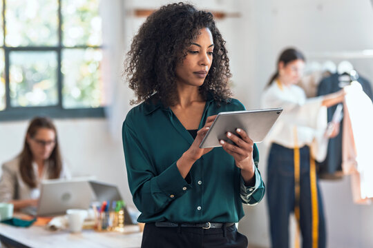 Businesswoman using tablet in collaborative office meeting room