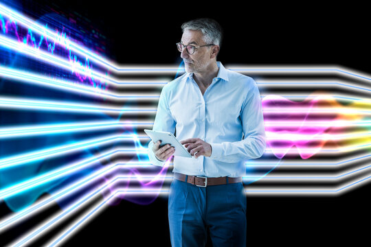 Businessman using tablet with futuristic data graphics background