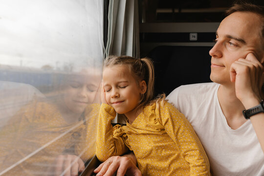 Father and daughter bonding while traveling by train