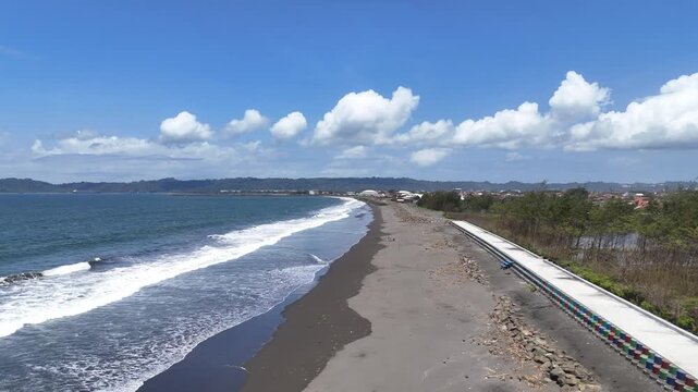 Aerial view of the breakwater from above at Kemiren Beach, Cilacap, 4K