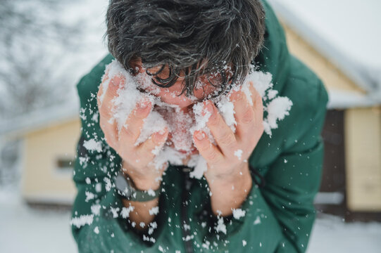 Person with face in snow fooling around outdoors in winter