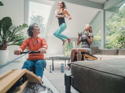 Family exercising together at home with calisthenics and rowing
