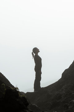 Silhouette standing on misty mountain landscape in Java