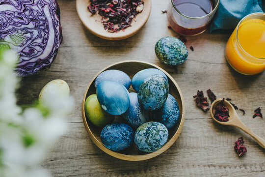 Natural dyed Easter eggs with red cabbage and turmeric in kitchen setting