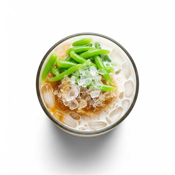 Top-down view of a refreshing glass of cendol, a traditional Southeast Asian dessert with green jelly, coconut milk, brown sugar, and crushed ice.