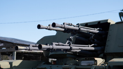 Close View Of Multiple Gun Barrels And Targeting Systems. Multiple Forwardpointing Gun Barrels With Targeting Optics Showcasing Heavy Military Firepower Equipment © bisonov