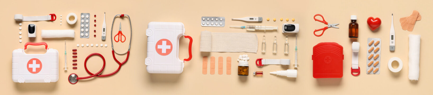 Content of first aid kit on beige background, top view