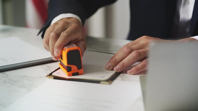U.S. male embassy official putting multiple denied stamps in Mexican passport