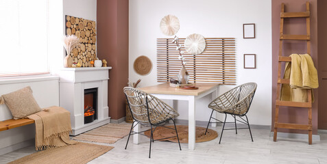 Obraz premium Interior of stylish dining room with table, fireplace and bench