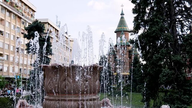 Water fountain display in front of an orthodox cathedral in a Timisoara square, Romania