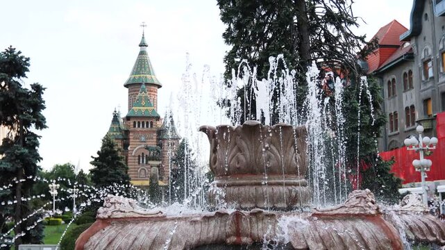 Water fountain display in front of an orthodox cathedral in a Timisoara square, Romania