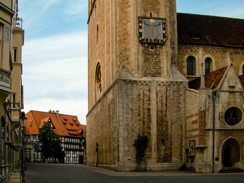 A view of a church and other buildings in a town square.