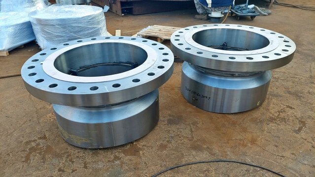 Large machined steel flanges for industrial piping system in workshop