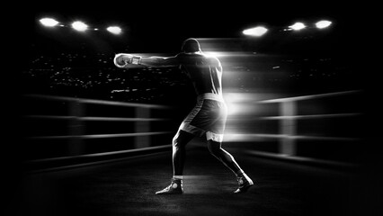 Boxing athlete punching with light trail motion effect in stadium ring for sports advertising, fight promotion and fitness campaign visuals. © master1305
