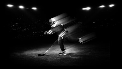 Ice hockey athlete skating with speed trail motion effect under arena lights for sports advertising, winter sports promotion and competition campaigns. © master1305