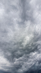 Obraz premium Vertical Dramatic Storm Cloud Texture Background In Gray Sky