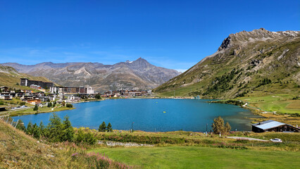 Fototapeta premium Panoramic view of the lake Lac de Tignes and the village in the French Alps valley, Savoie, France, Europe.