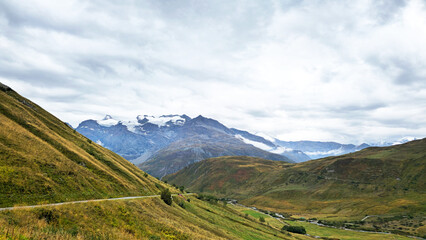 Fototapeta premium Winding mountain road Route du Col de l’Iseran traversing a high-altitude Alpine landscape, Savoie, France, Europe.