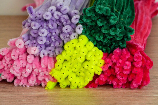 Colorful decorative wire on a wooden table, close-up photo. Needlework