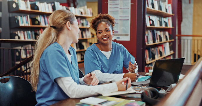Women, medical students and talk with laptop at library for research, smile and brainstorming at campus. Girl, healthcare scholarship and computer with insight, discussion and listen at university