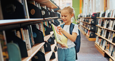 Naklejka premium Smile, child and girl with book in library, language skills and vocabulary development for education. Literacy knowledge, fairy tale story and kid with literature for reading, academic growth or info