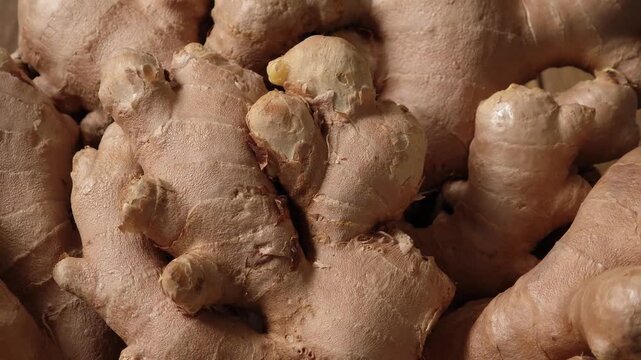 Fresh ginger in a wooden plate.	