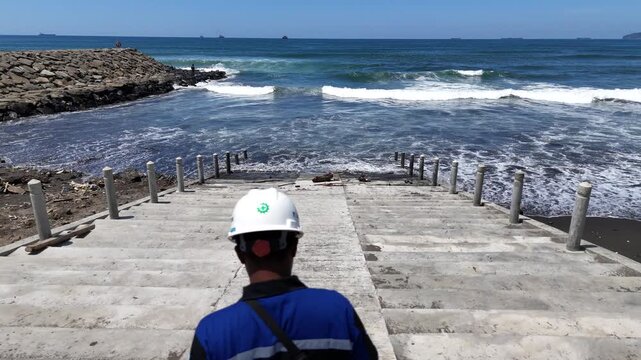 Aerial view of the breakwater from above at Kemiren Beach, Cilacap, 4K