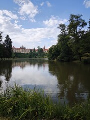 Fototapeta premium Scenic view of Pruhonice Castle in a sunny summer day with beautiful reflection in the pond,