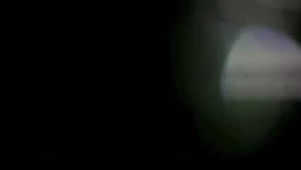 Creating an ethereal and captivating visual experience, this striking image features subtle, out-of-focus light leaks gently illuminating a deep, rich black background, providing a versatile and artis © zain