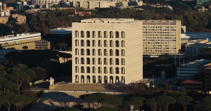 Aerial view of the Palazzo della Civilta Italiana, a stark white building with arched windows, stands out against the surrounding urban landscape, Rome, Lazio, Italy.