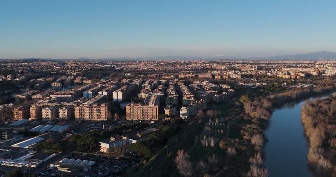 Aerial view of buildings and the Tiber river creating a stunning contrast of urban development and natural beauty in the expansive landscape, Rome, Lazio, Italy.