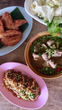 Traditional Thai Northern Food Set with Spicy Fish Larb, Tom Saap Soup and Crispy Fried Chicken 4k video footage